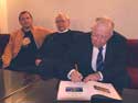 29. Artist V. Fomin, writer A.Mishin and E. Kiuru  translators of Kalevala by E. Lennrot  sign the book for the President of Finland. 2007. 